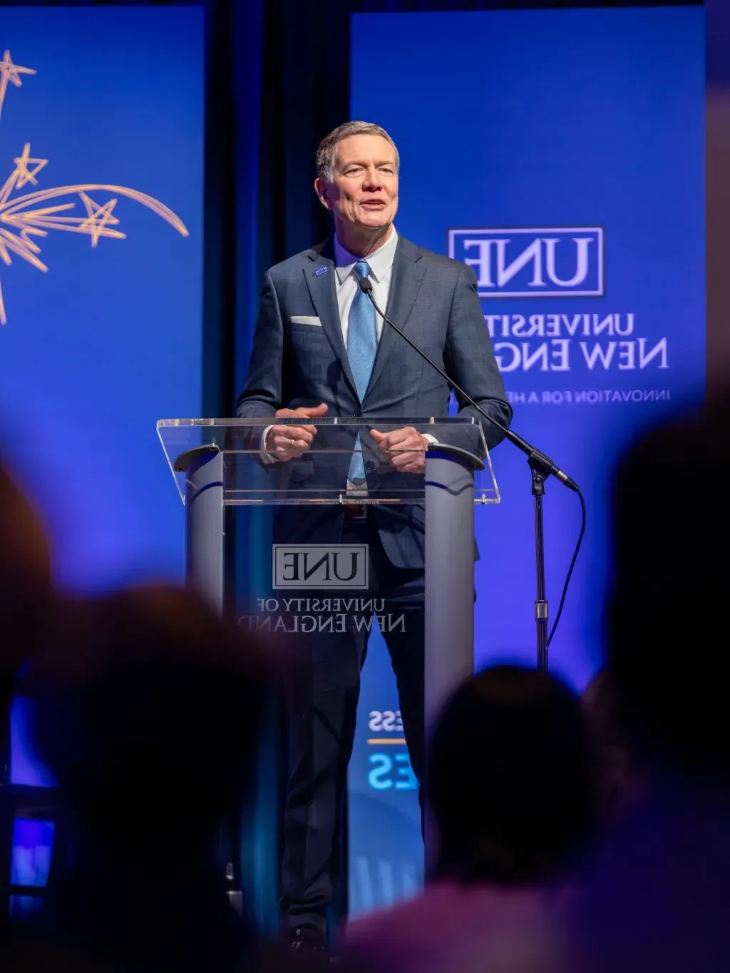 UNE President James Herbert speaks at the podium