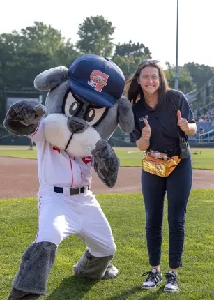 White poses with Slugger the mascot