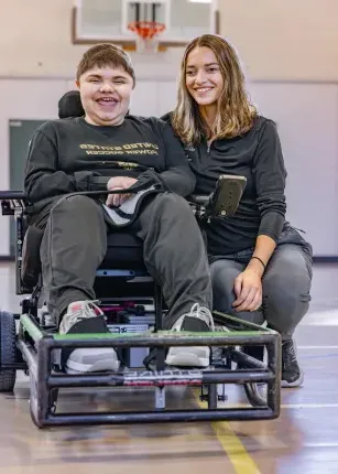 A UNE student poses with a Maine Adaptive client