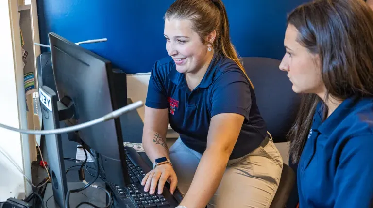 Fickett and White oversee ticket operations at the computer