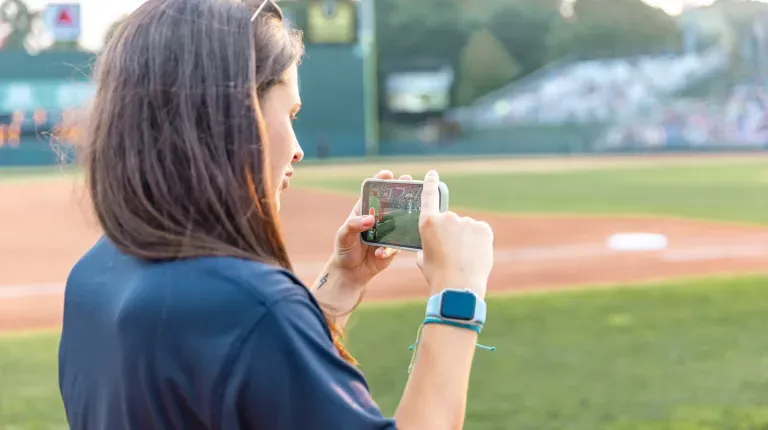 White films Slugger on her phone for social media