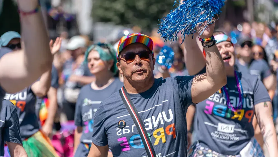 A UNE employee marches in the Pride parade in downtown Portland in June 2024